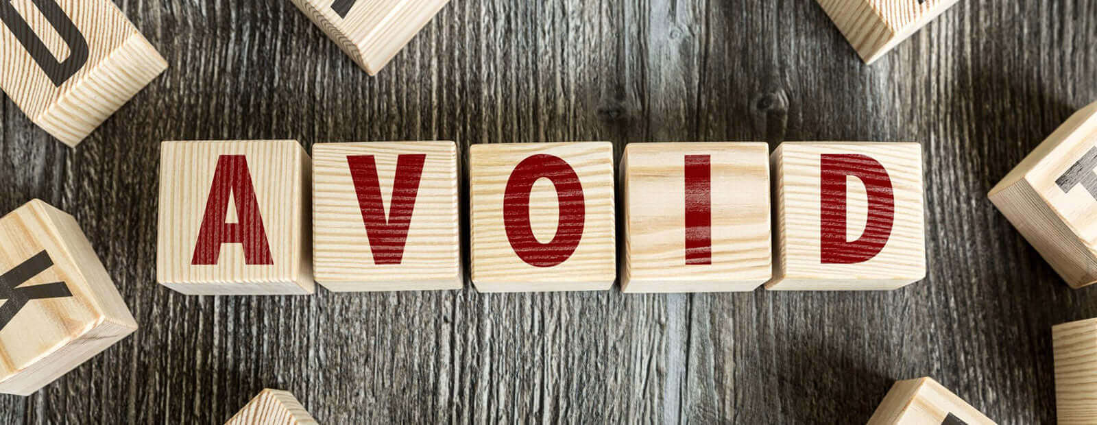 Avoid wooden blocks forming the word 'AVOID' with a focus on avoiding locksmith scams.