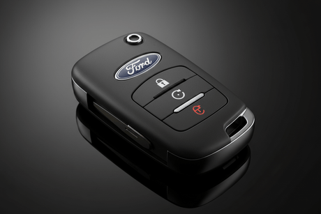 Exploring the Role of an Auto Locksmith with a Ford remote key fob on a sleek black background.