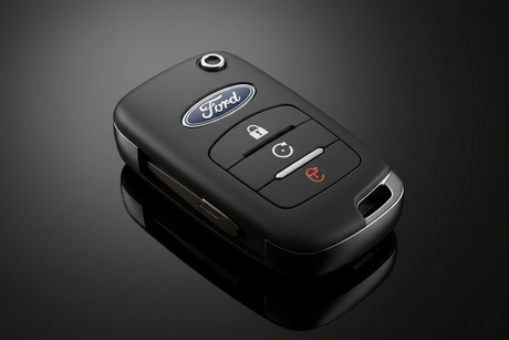 Exploring the Role of an Auto Locksmith with a Ford remote key fob on a sleek black background.